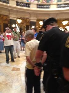 An 80 year old ‪#‎wiunion‬ defender arrested during the crackdown today at the Wisconsin State Capitol daily sing along.