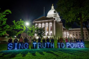 The OLB message is held on the Capitol lawn by many arrested during the past two weeks at the Solidarity Sing Along (photo credit: Michael Pecosky). 