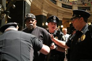 Cops arrest Vietnam Veteran Mr. Will Williams for singing at the state capitol in Madison [Jenna Pope photo, jennapope.com]