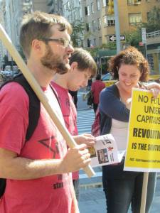 Scott Williams (holding sign) of Fight Imperialism Stand Together (FIST) participating in a protest against the World Business Forum in New York City October 8, 2014.