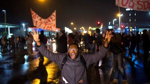 A protester, demanding the criminal indictment of a white police officer who shot dead an unarmed black teenager in August, shouts slogans while stopping traffic while marching through a suburb in St. Louis, Missouri November 23, 2014. (Reuters/Adrees Latif)